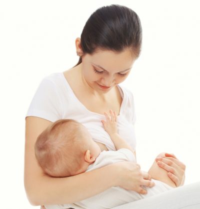 Happy mother feeding breast her baby over white background